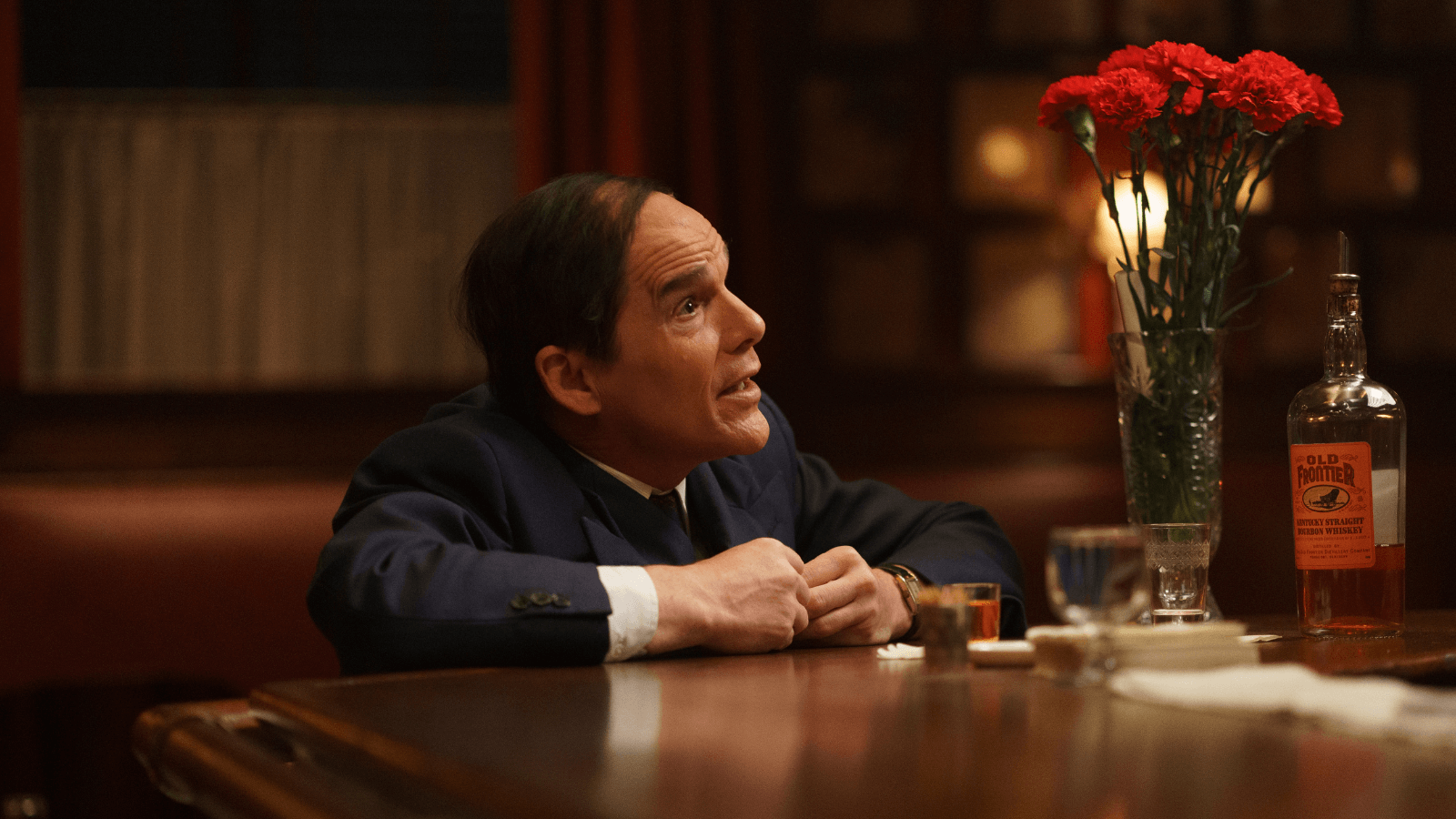 Ethan Hawke as Lorenz Hart seated at a bar in Blue Moon (2025)