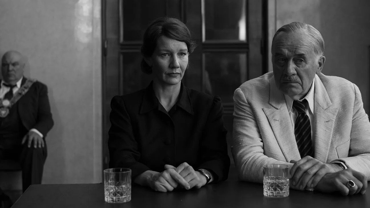 Fatherland (2026)  sandra-huller-hans-zischler-sitting-at-desk-still