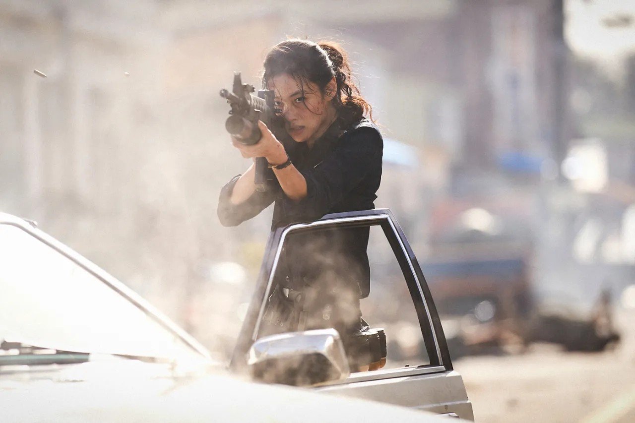 Hope (2026) Hoyeon as a cop firing the gun still