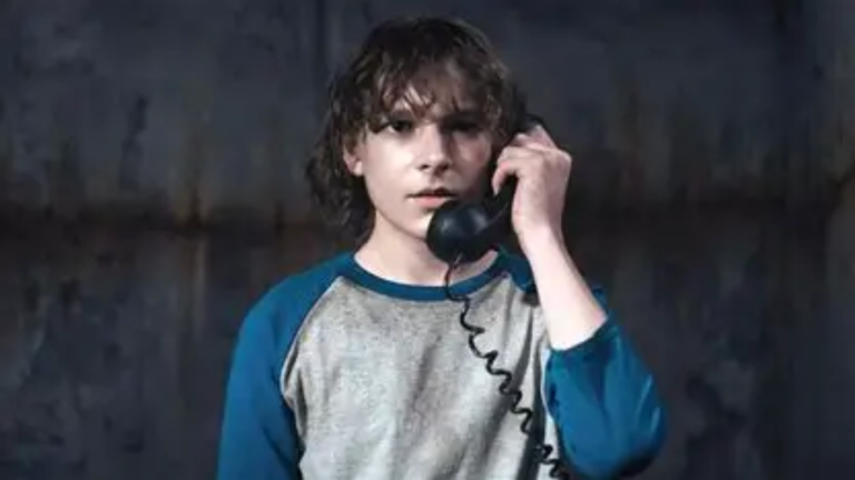 The Black Phone (2021) - Finn (Mason Thames) talking on a disconnected phone still